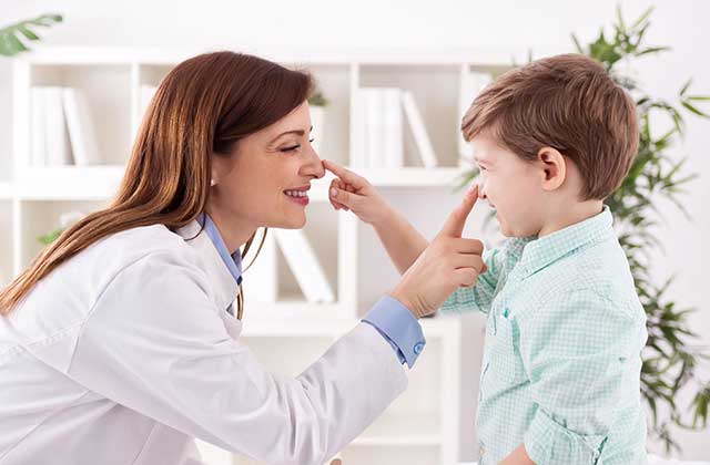 Doctor and child enjoy each other